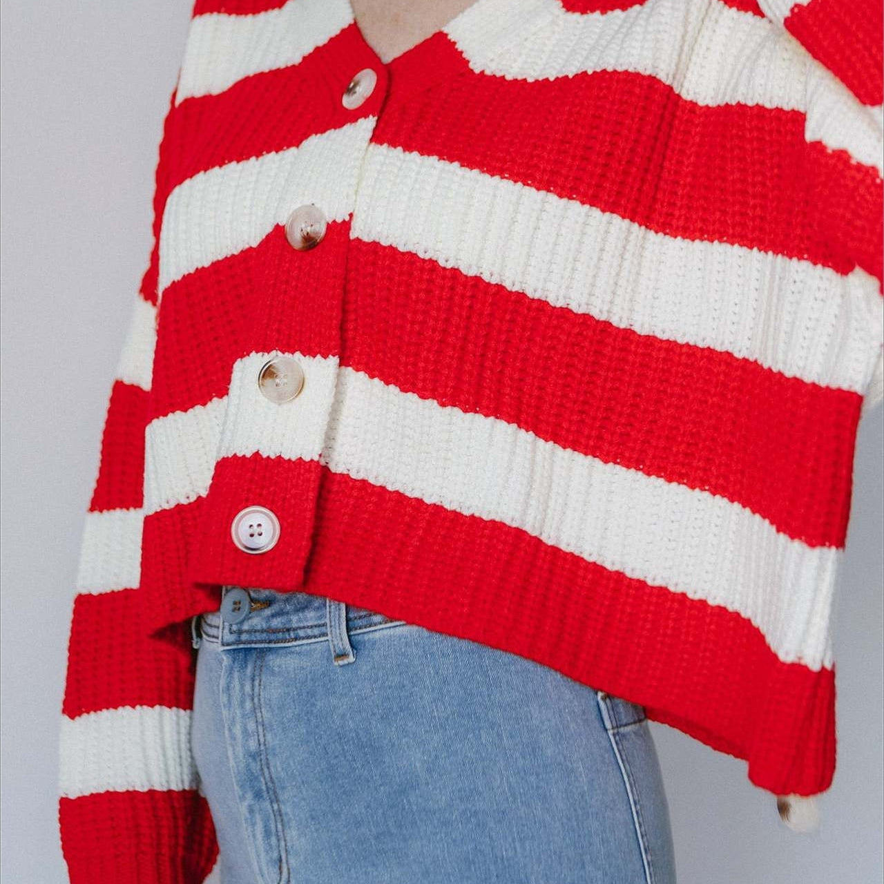 Csíkos kötött mellény széles V-nyakkal és hosszú ujjakkal