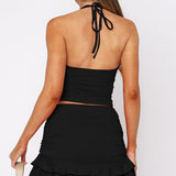 Szexi, testhezálló szoknya szett V-nyakkal és kivágásokkal, hát nélküli toppal.