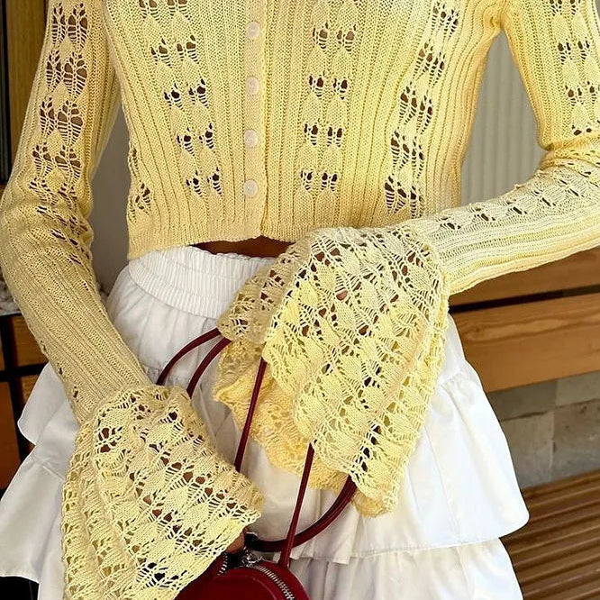 Hosszú ujjú, V-nyakú mellény áttört kötéssel